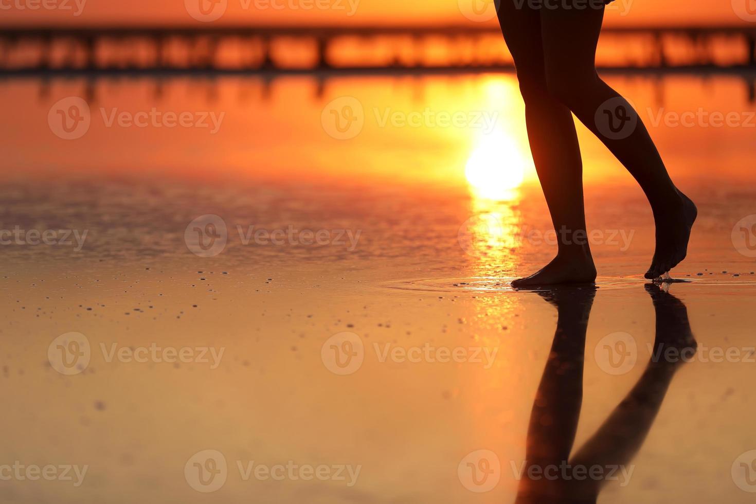 side view Footage of Beautiful Young Woman in the Swimsuit Walking on the Beach towards the Sea. Girl is Very Slim photo