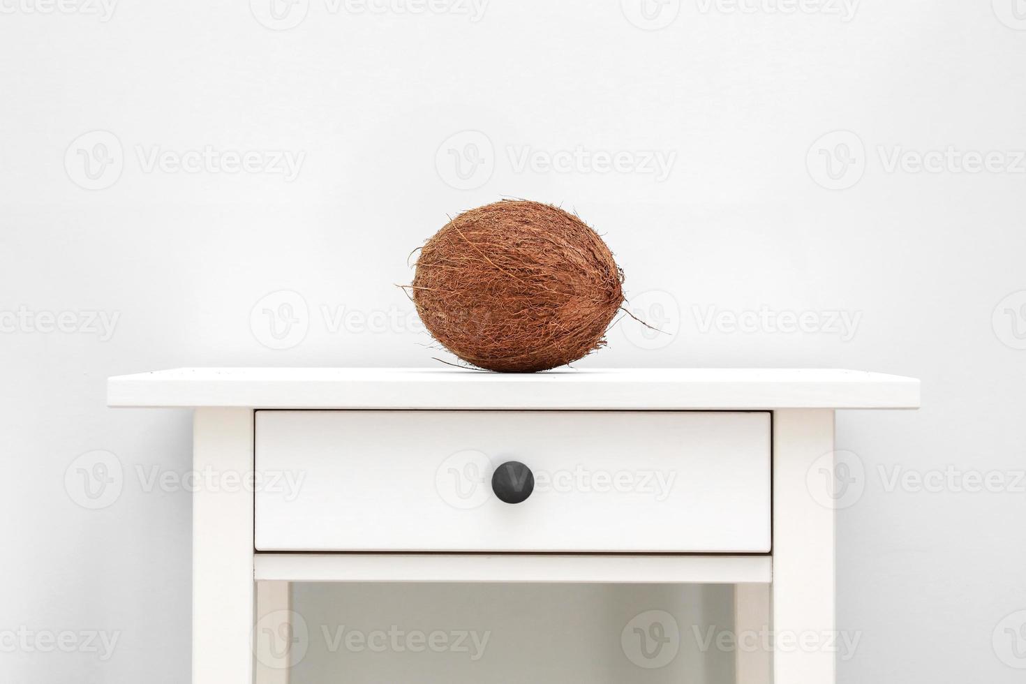 Homemade coconut products on white wooden table background. whole coconut on white table. Summer tropical concept photo