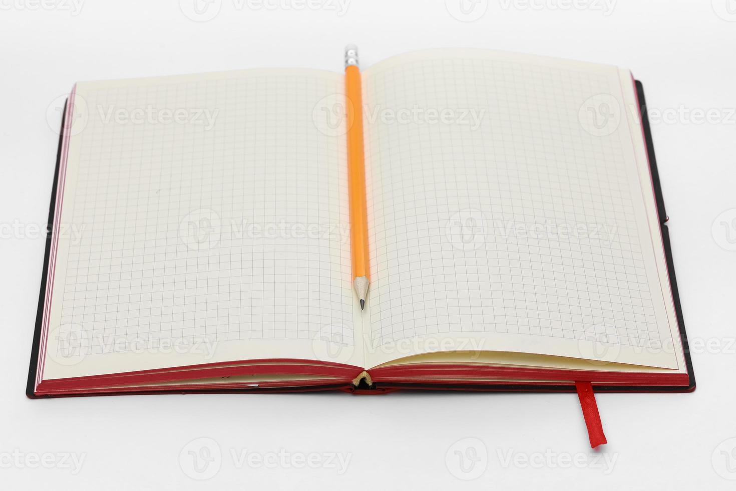 Business concept. Top view collection of notebook, white open flip curl rolled page and pencil on background for mockup photo
