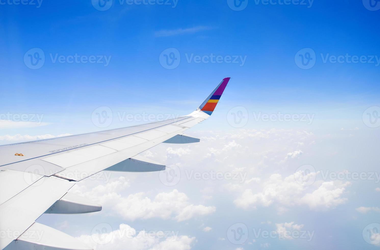 Wing of an airplane flying in the sky photo