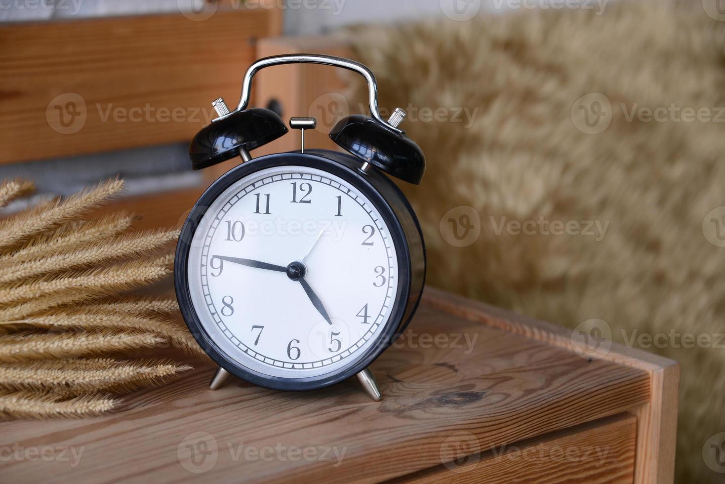 Retro Alarm Clock on wooden desk photo
