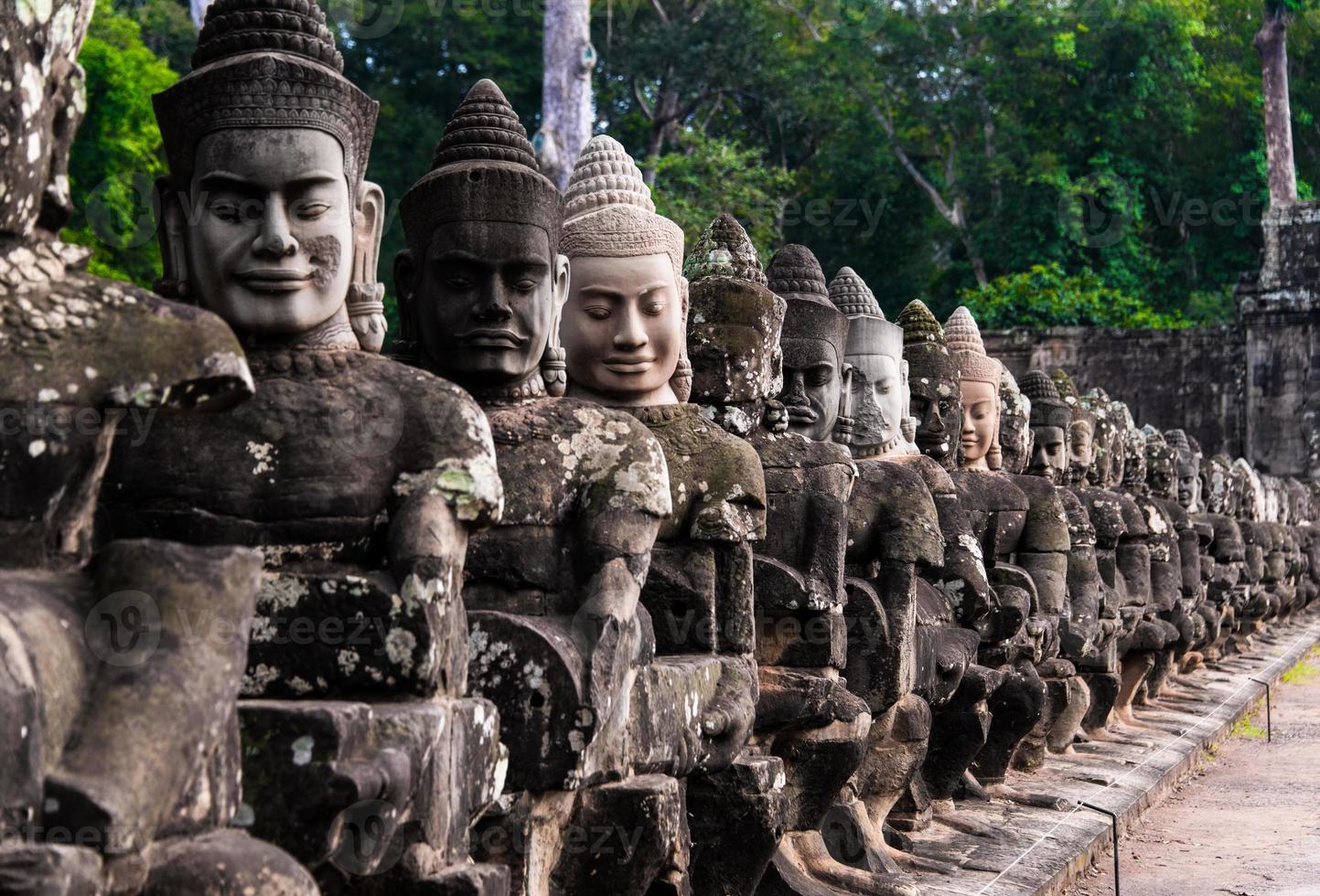 The stone of buddha image at Stone Gate of Angkor Thom in Cambodia photo