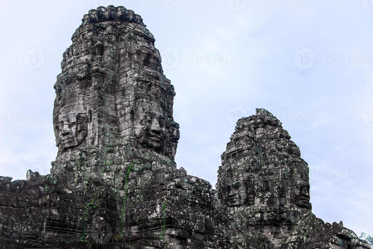 Prasat Bayon with smiling stone faces is the central temple of Angkor Thom Complex, Siem Reap, Cambodia. Ancient Khmer architecture and famous Cambodian landmark, World Heritage. photo