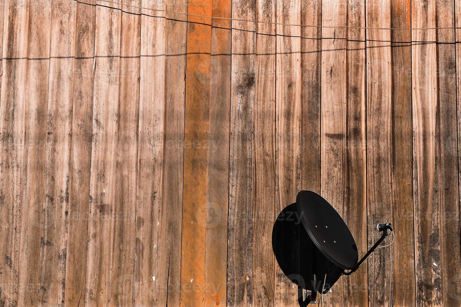 Satellite Dishe against with wooden wall photo