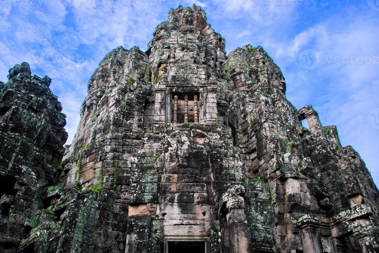 Prasat Bayon with smiling stone faces is the central temple of Angkor Thom Complex, Siem Reap, Cambodia. Ancient Khmer architecture and famous Cambodian landmark, World Heritage. photo