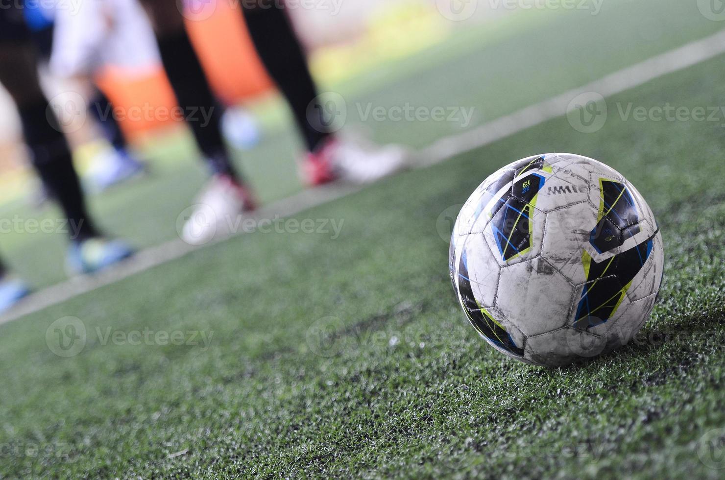 Football and free kick in a green field photo