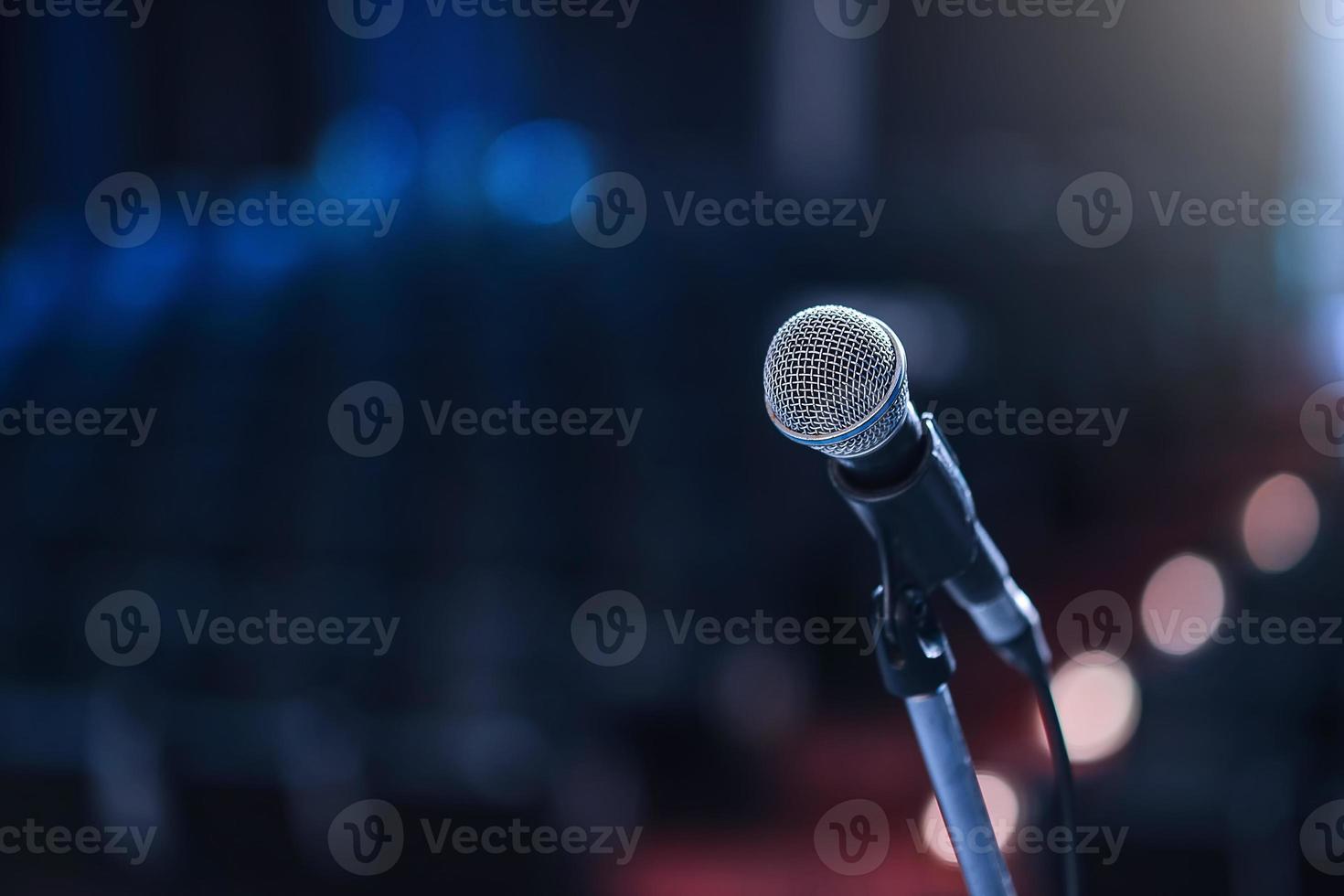 Close up of microphone in concert hall or conference room photo