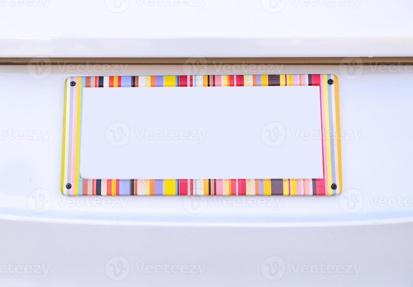 number plate of car with rainbow color frame photo