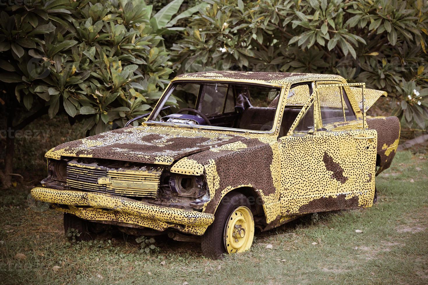 Yellow vintage broken car photo