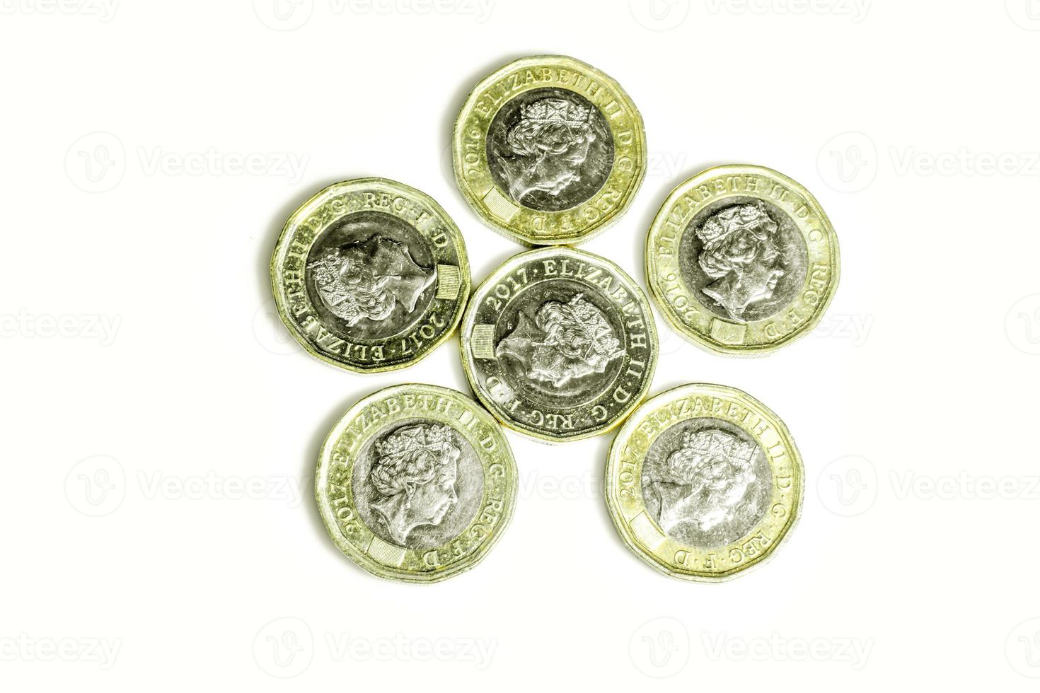 British currency the new one pounds coins put on look like a star picture isolate on white background. photo