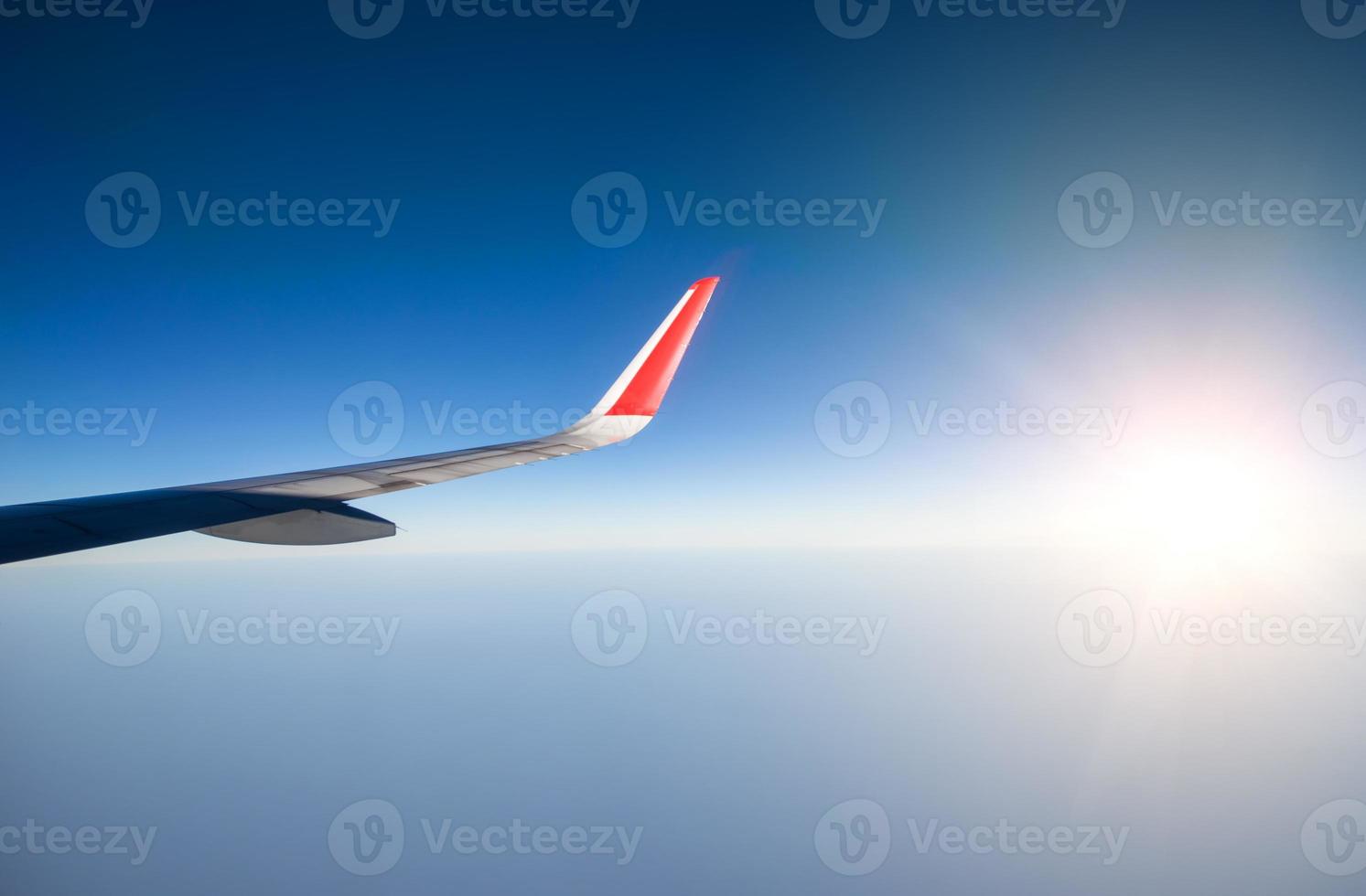 Wing of an airplane flying in the sky photo
