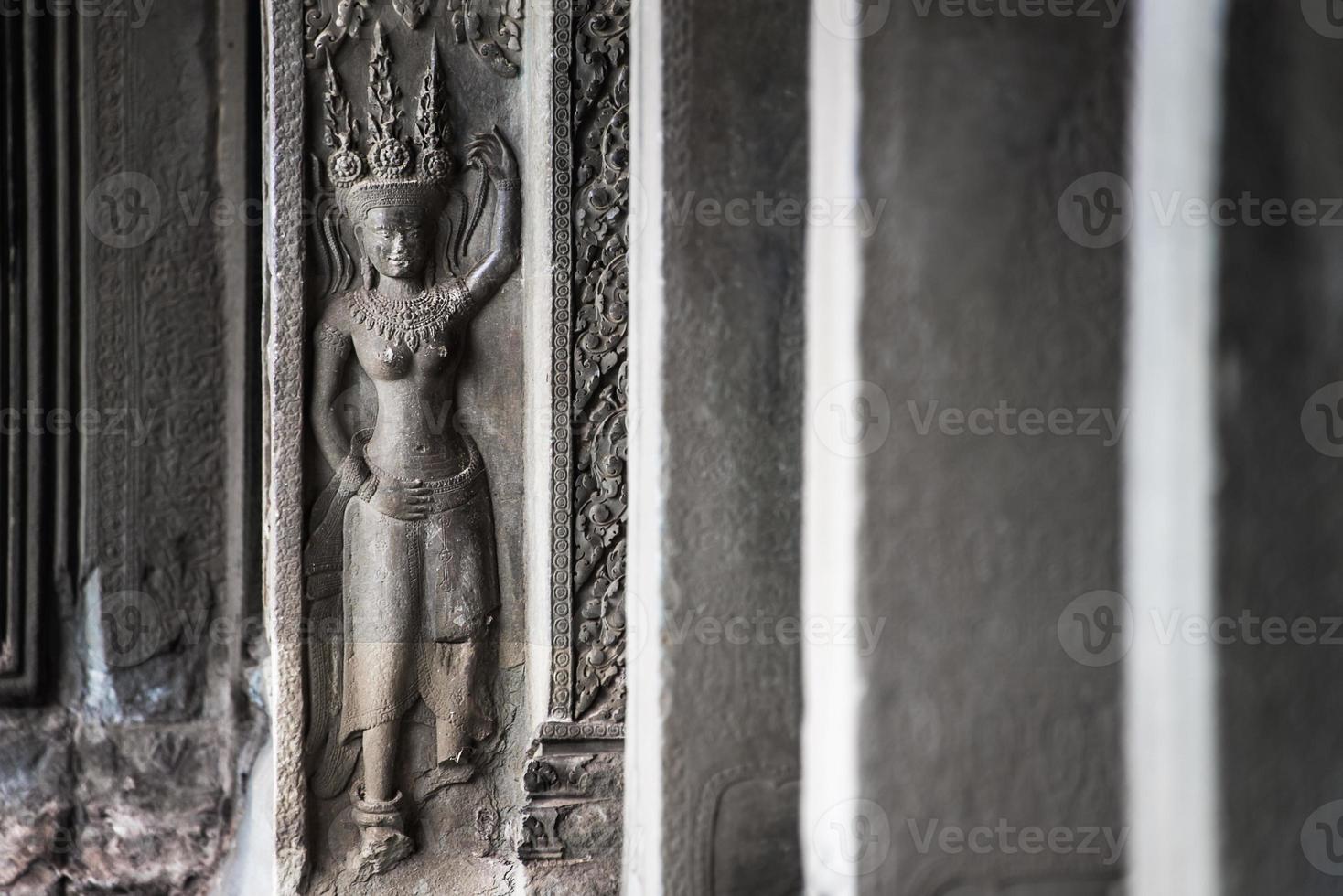 Detail of stone carvings of Apsara is a beautiful and seductive girl of Hindu mythology at Angkor Wat, Cambodia photo