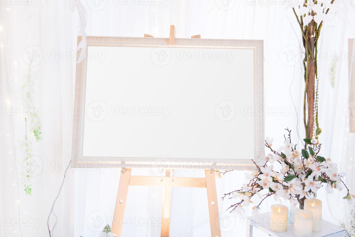 Blank  frame on the table and flower decoration photo