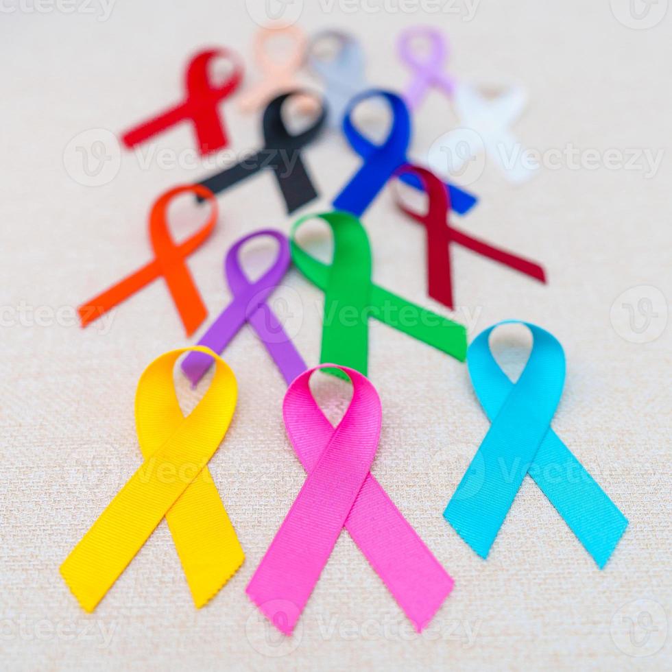 World cancer day, February 4. Colorful ribbons for supporting people living and illness. Healthcare, fighting, medical and National Cancer Survival day, Autism awareness day concept photo