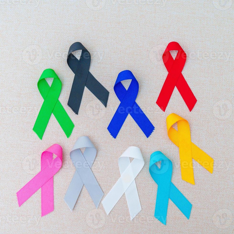 World cancer day, February 4. Colorful ribbons for supporting people living and illness. Healthcare, fighting, medical and National Cancer Survival day, Autism awareness day concept photo