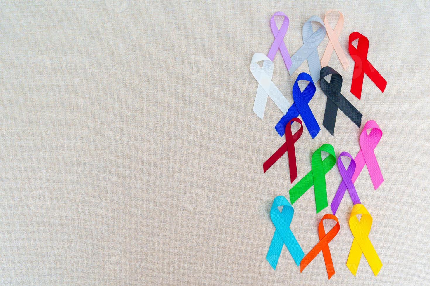 World cancer day, February 4. Colorful ribbons for supporting people living and illness. Healthcare, fighting, medical and National Cancer Survival day, Autism awareness day concept photo