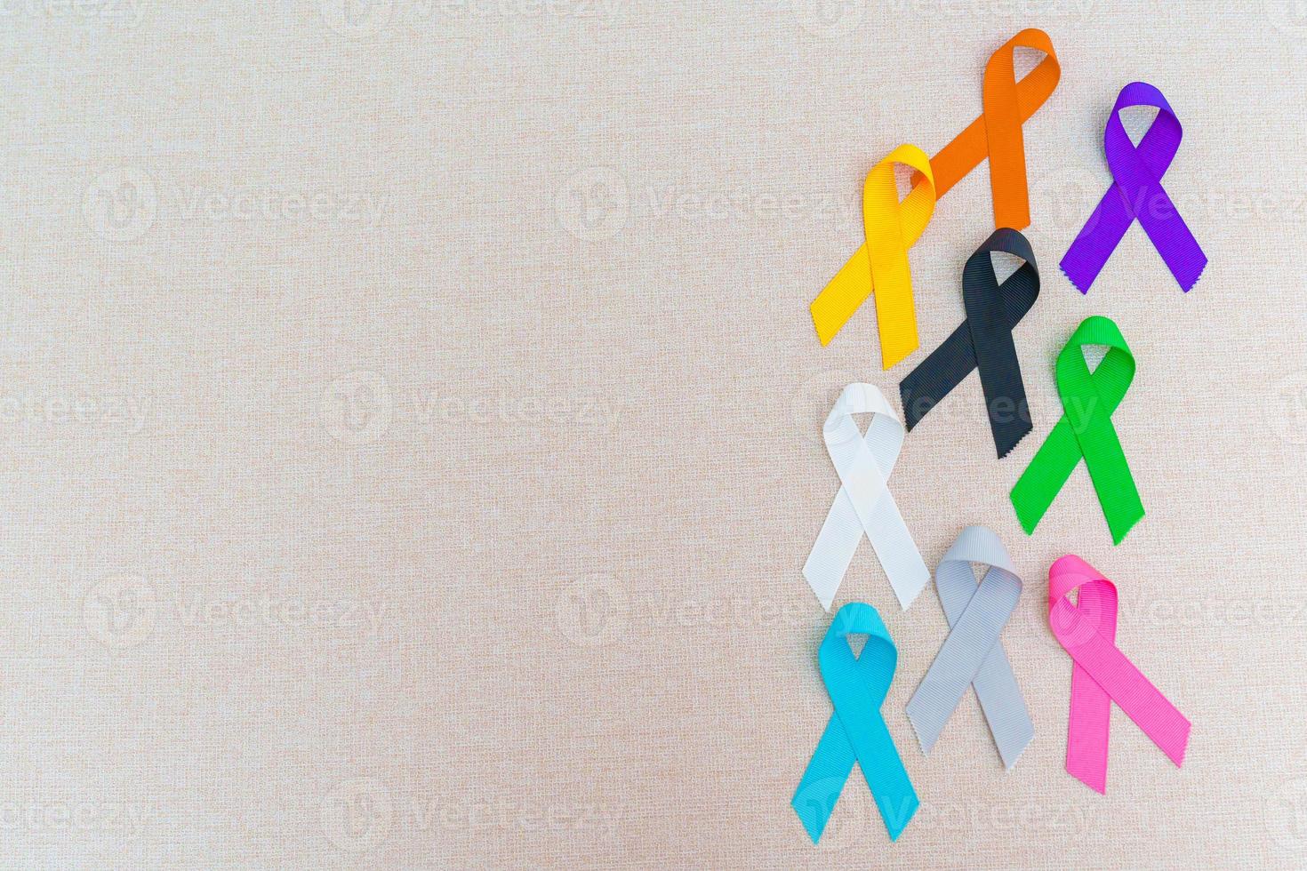 World cancer day, February 4. Colorful ribbons for supporting people living and illness. Healthcare, fighting, medical and National Cancer Survival day, Autism awareness day concept photo