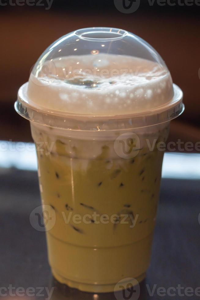 Iced green tea with milk foam photo