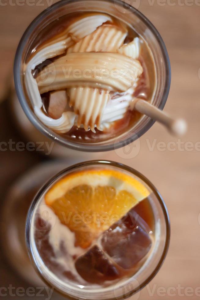 Glass of americano mixed with coconut and orange juice photo