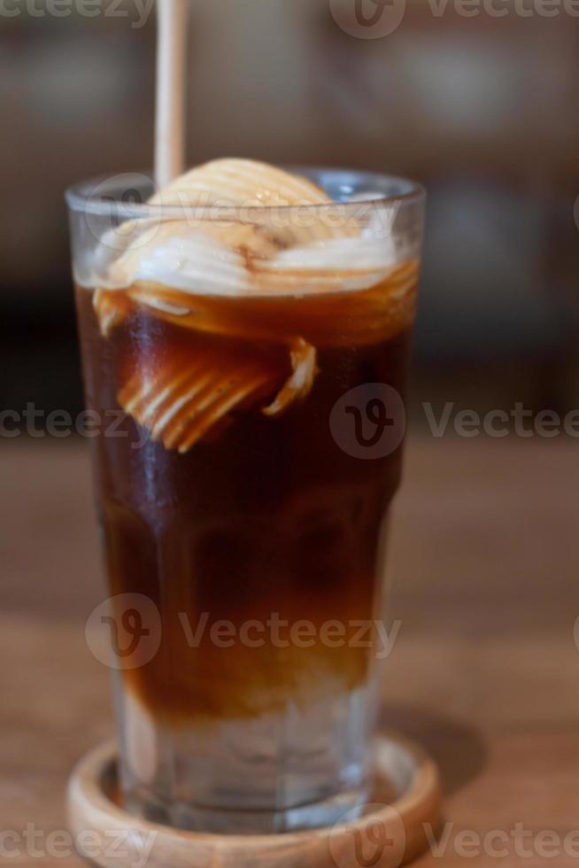 Glass of americano mixed with coconut photo