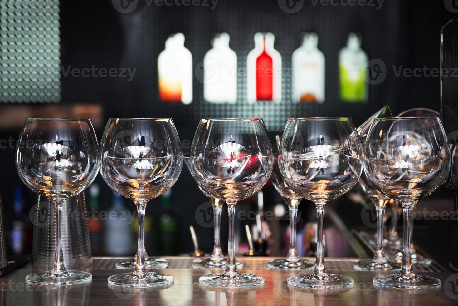 Empty Wine glasses on the background of the bar photo