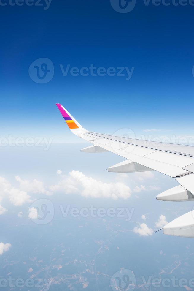 Wing of an airplane flying in the sky photo