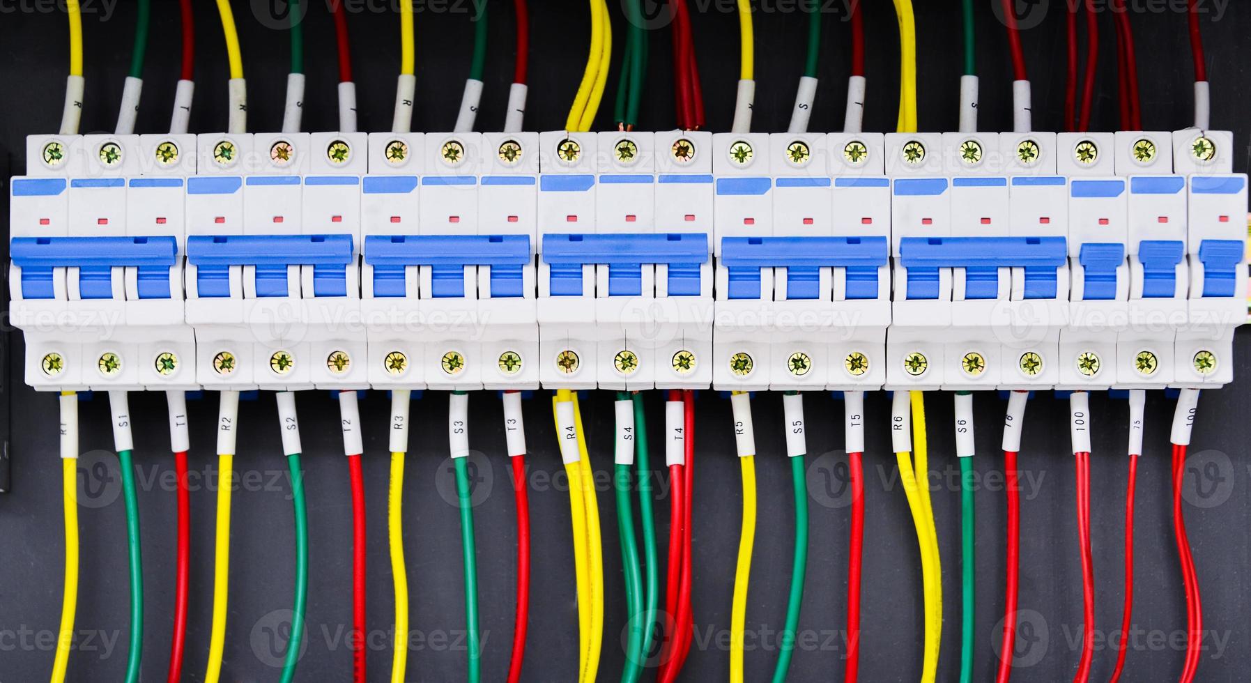 Close up circuit breakers and wire in control panel photo