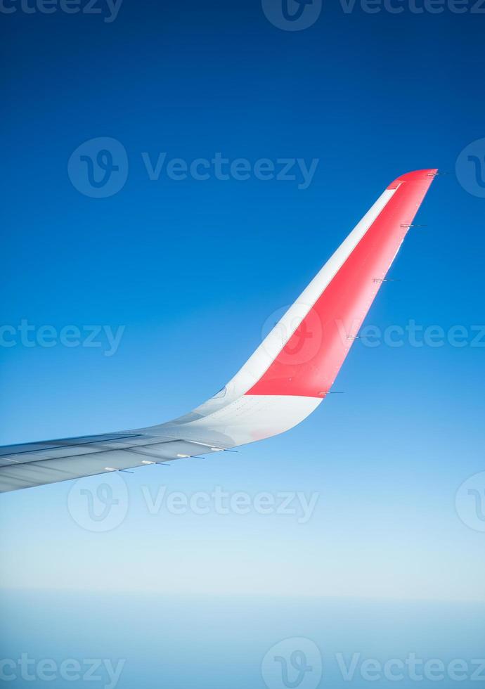 Wing of an airplane flying in the sky photo