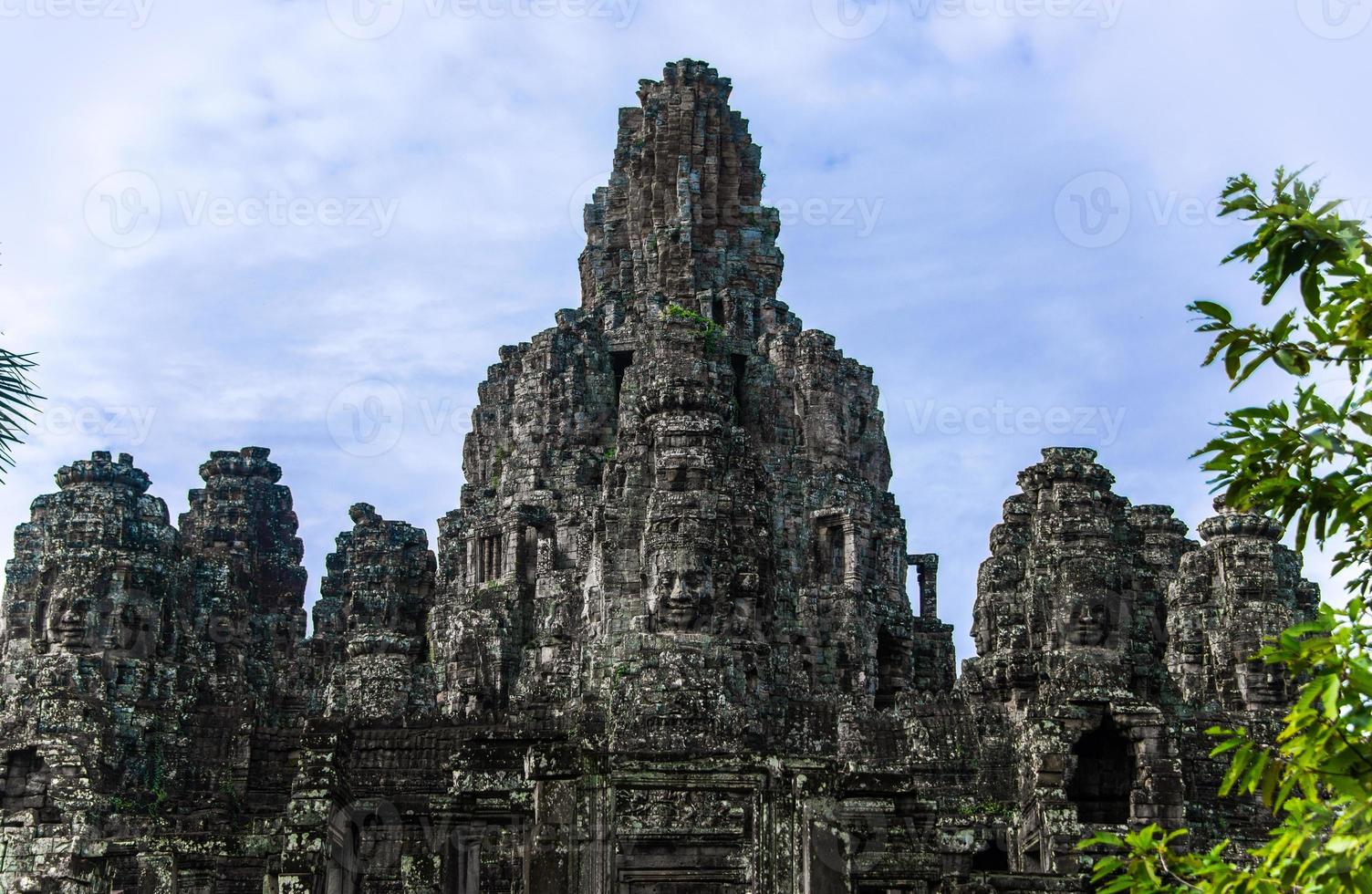 Prasat Bayon with smiling stone faces is the central temple of Angkor Thom Complex, Siem Reap, Cambodia. Ancient Khmer architecture and famous Cambodian landmark, World Heritage. photo