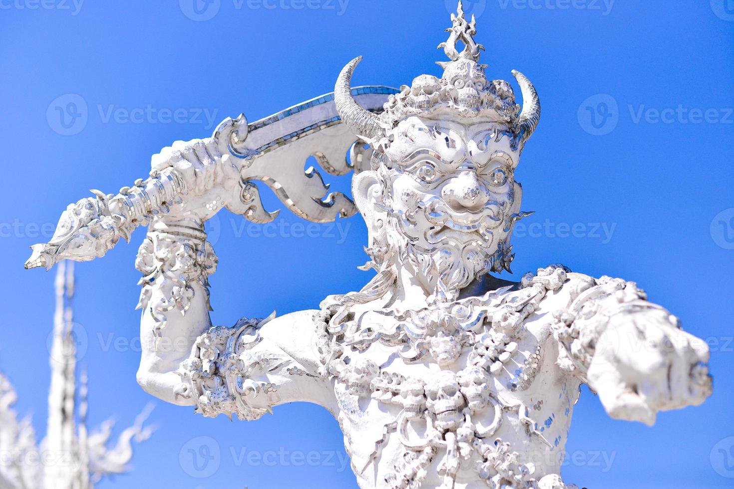 Angel of death statue in Wat Rong Khun, the famous white temple of Thailand photo