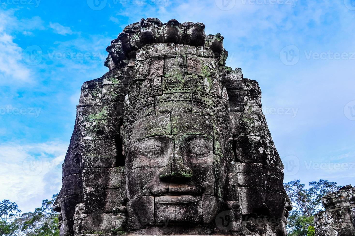 Prasat Bayon with smiling stone faces is the central temple of Angkor Thom Complex, Siem Reap, Cambodia. Ancient Khmer architecture and famous Cambodian landmark, World Heritage. photo