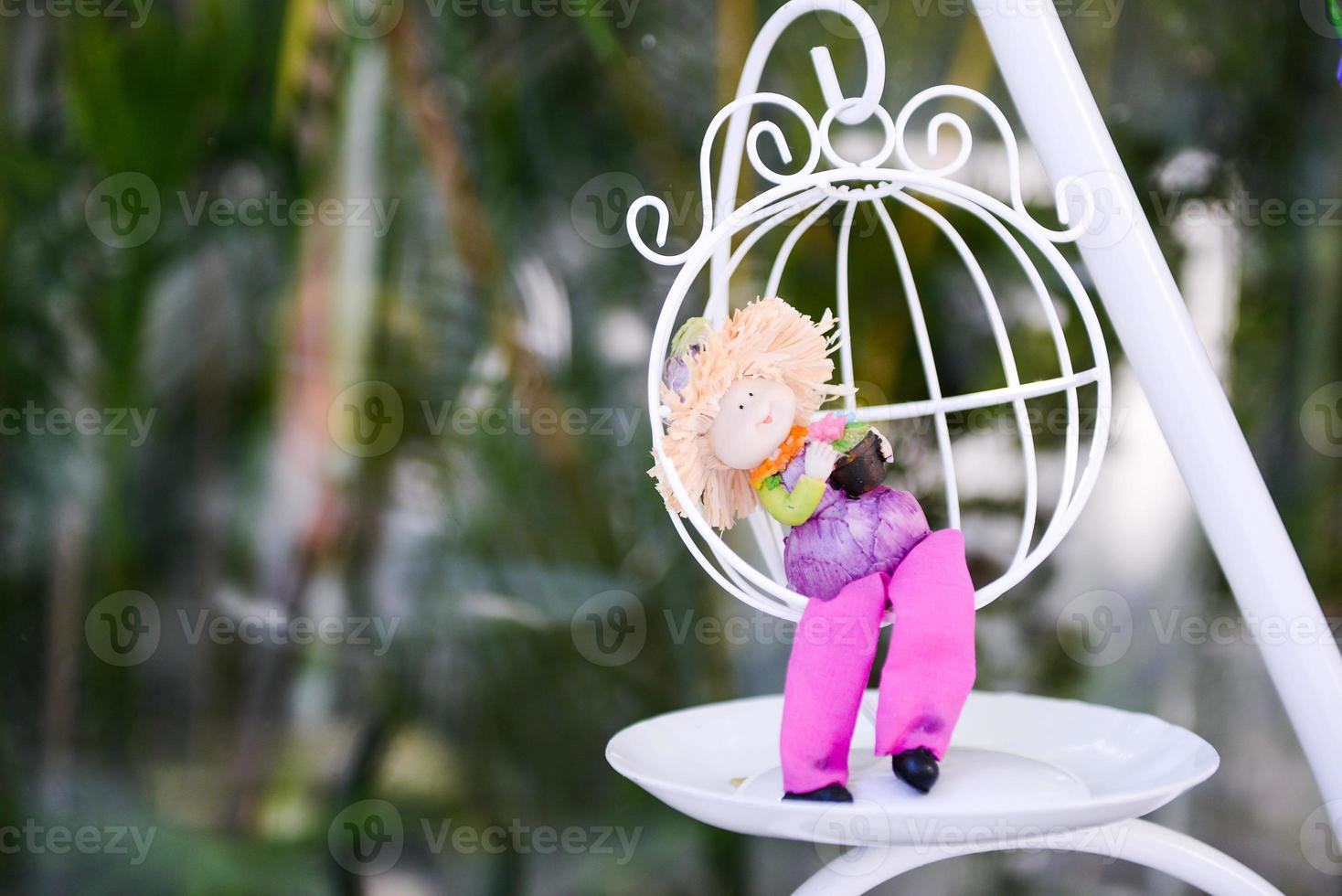 The dcoration of tiny doll and white chair photo