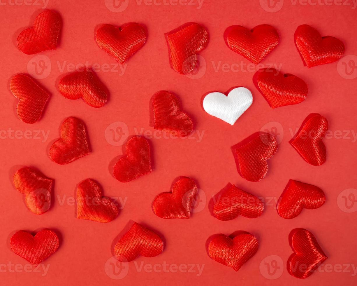 Red and white hearts on a red background. Valentine's day holiday. Symbol of love. photo