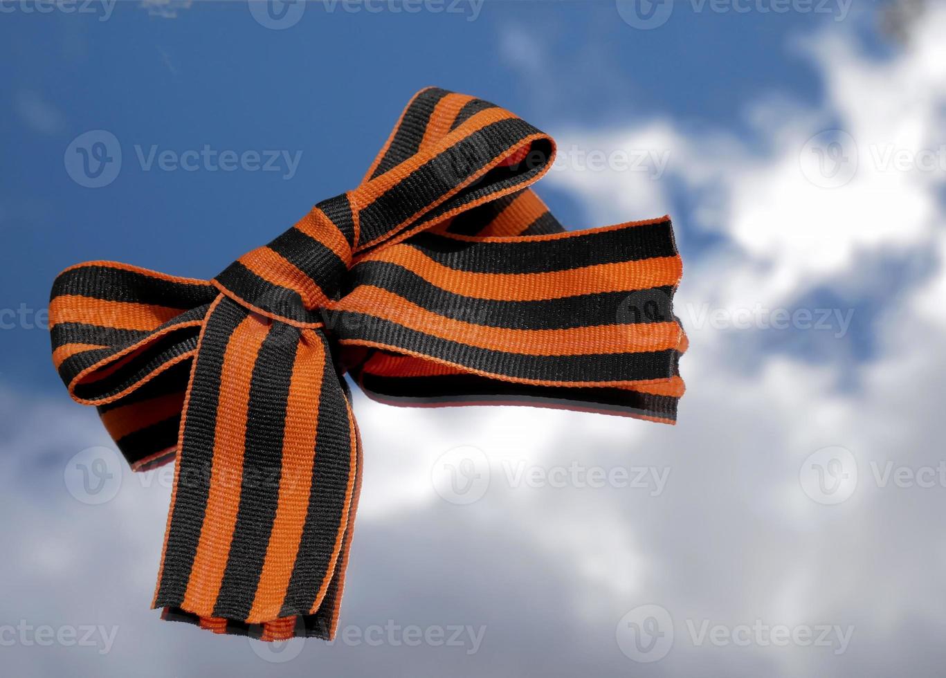 9th May. The concept of the Great Victory Day of 1941-1945 and Defender of the Fatherland Day. St. George ribbon on a blue sky background photo