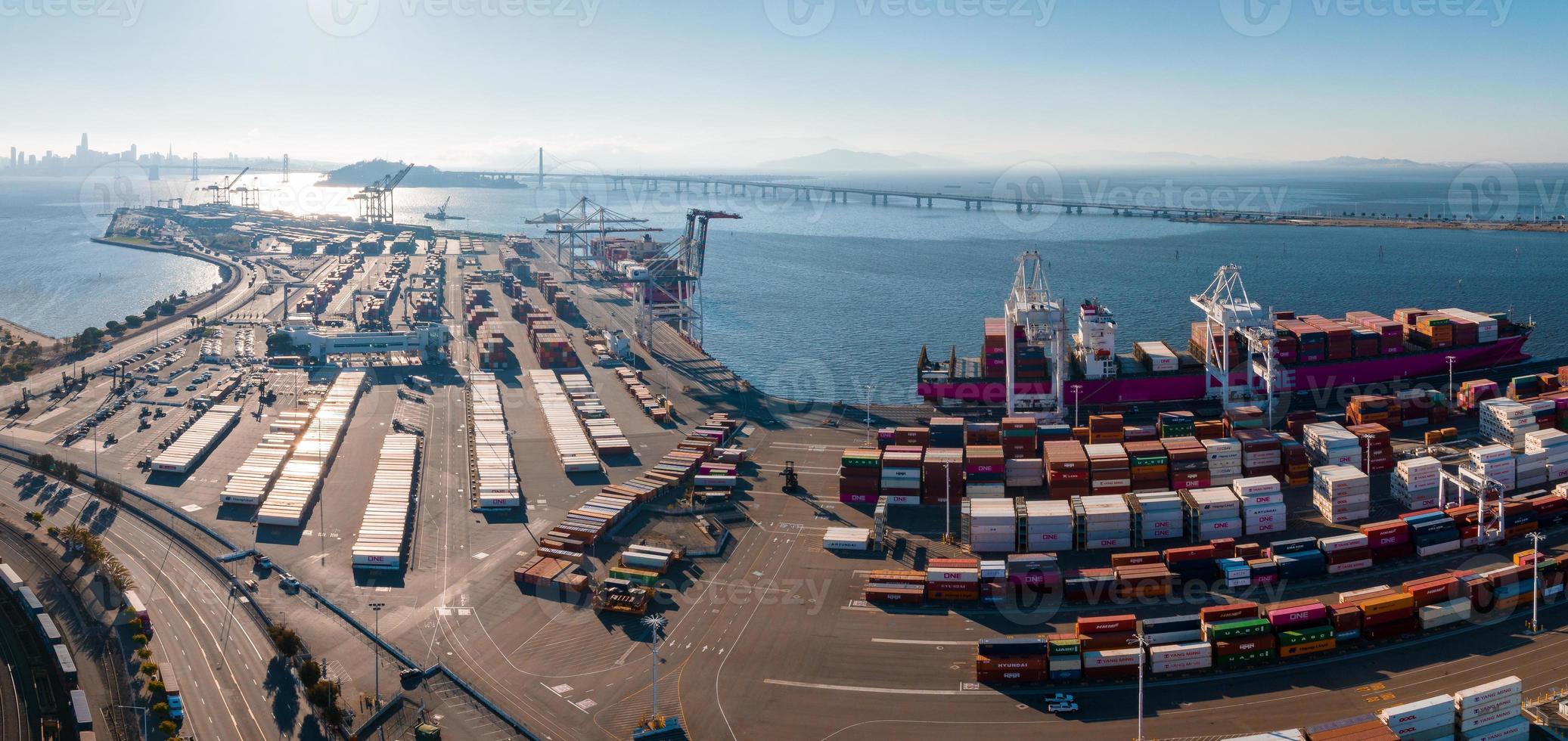 The Oakland Outer Harbor aerial view. Loaded trucks moving by Container cranes. photo