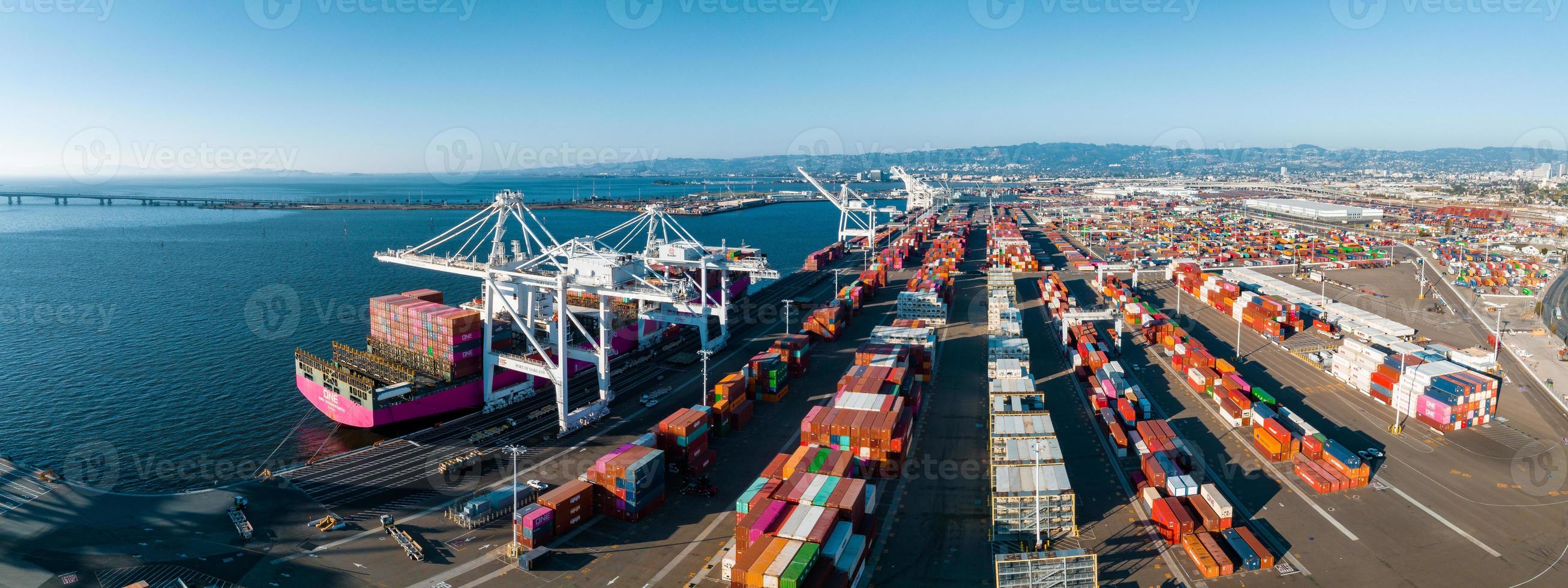 The Oakland Outer Harbor aerial view. Loaded trucks moving by Container cranes. photo