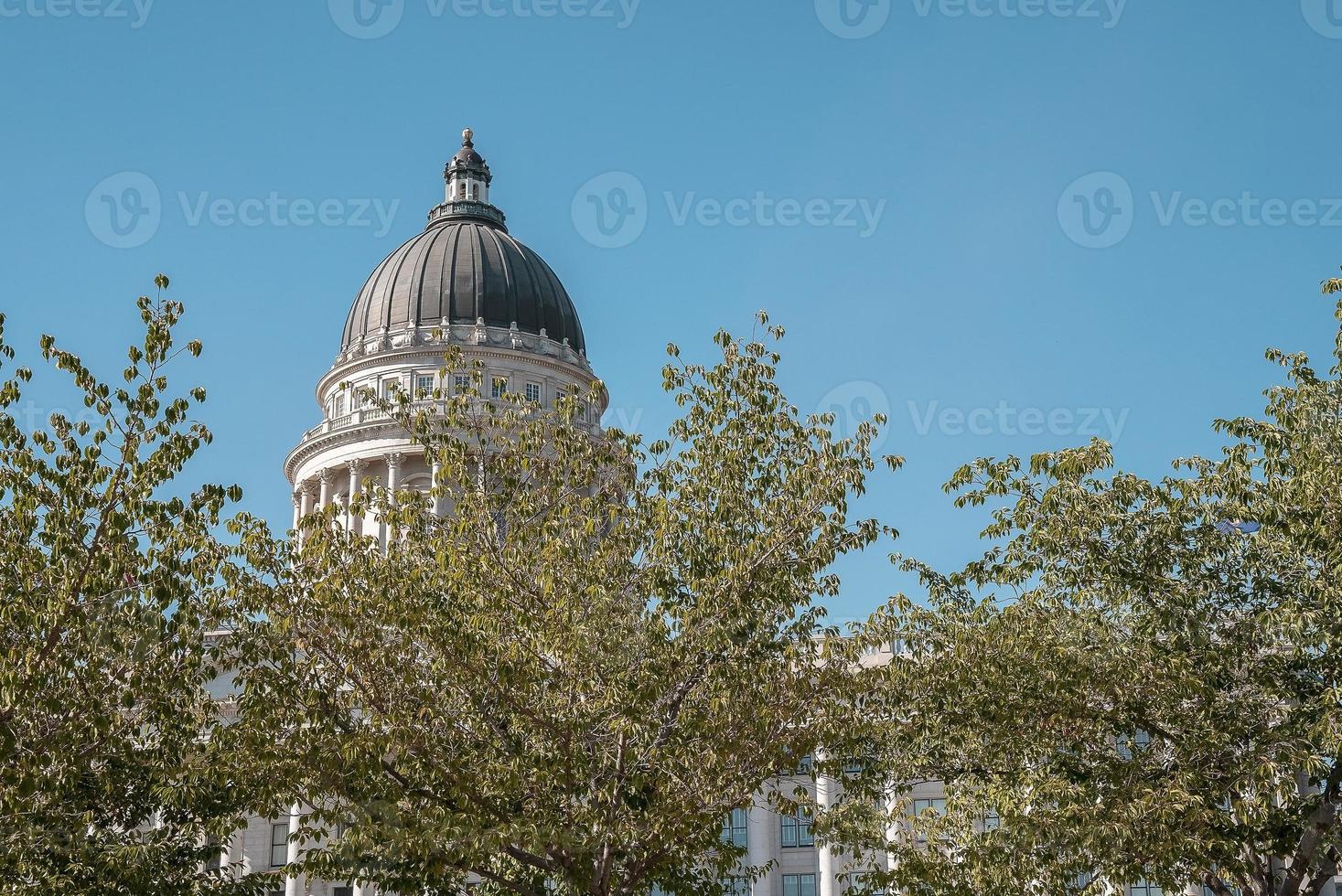 View of State Capitol building and trees with clear blue sky in background photo