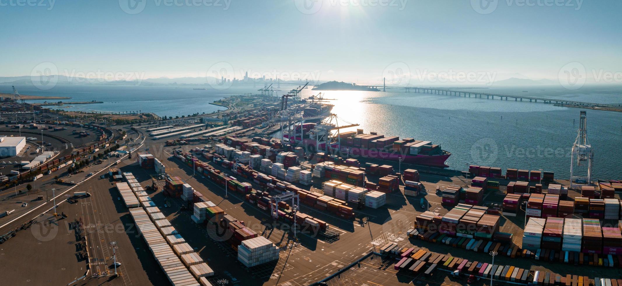 The Oakland Outer Harbor aerial view. Loaded trucks moving by Container cranes. photo