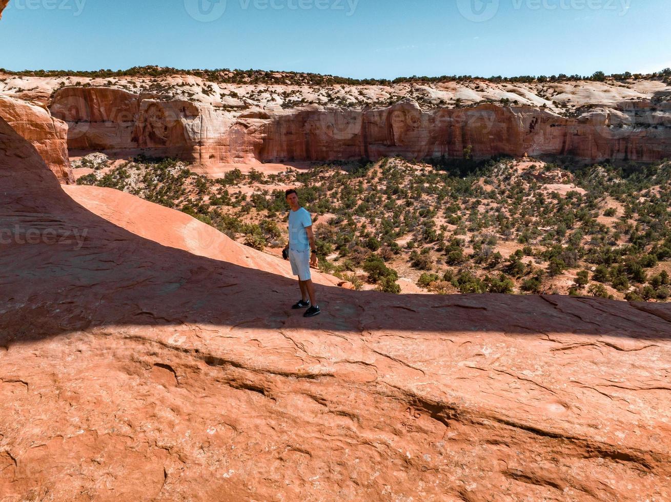 Young man standing in the Arches National Park in Arizona, USA. photo