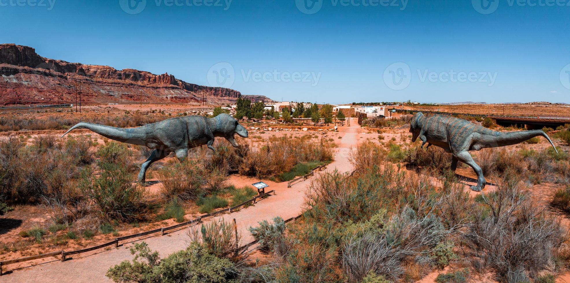 Allosaurus fragilis as well as Tyrannosaurus Rex or T-eEx dinosaurs in the Moab desert photo