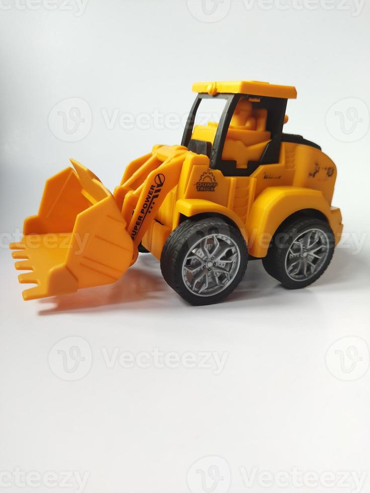 Toy of tractor for kids isolated with white background photo