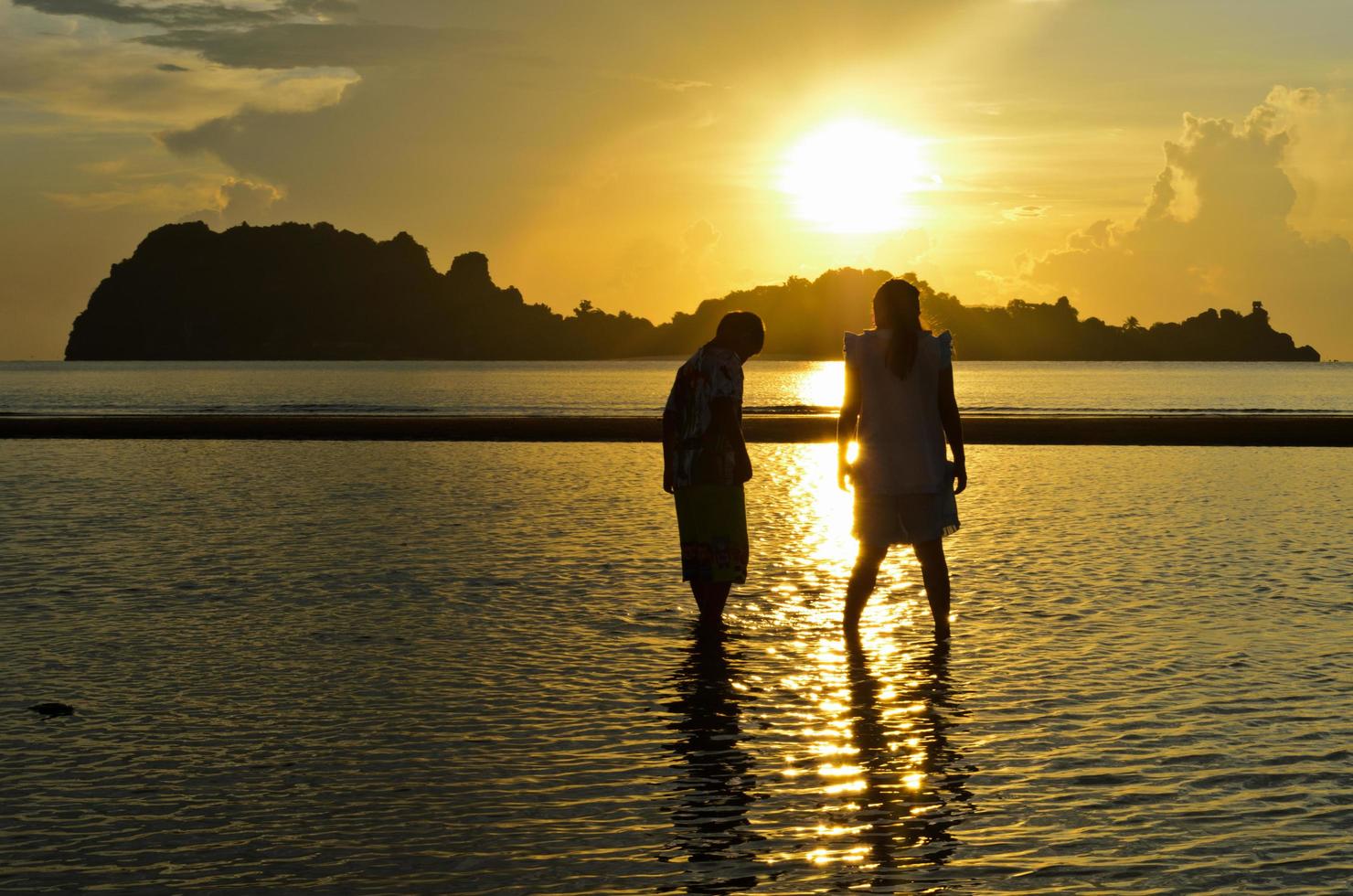 Girls and boy on the Hat Sai Ri beach during sunrise photo