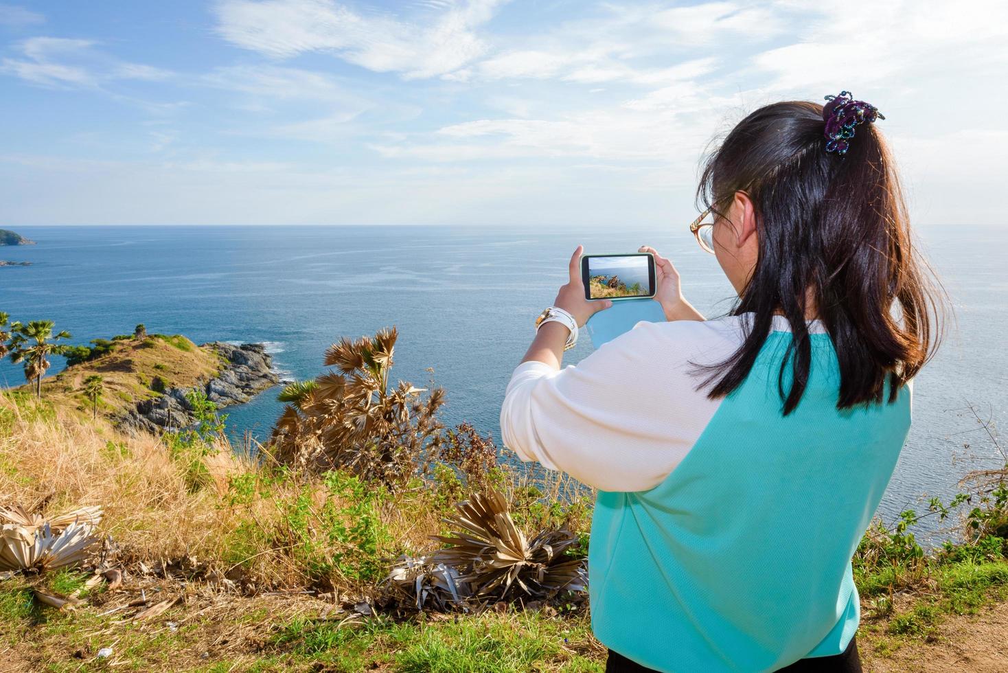 Woman taking photograph with smartphone photo
