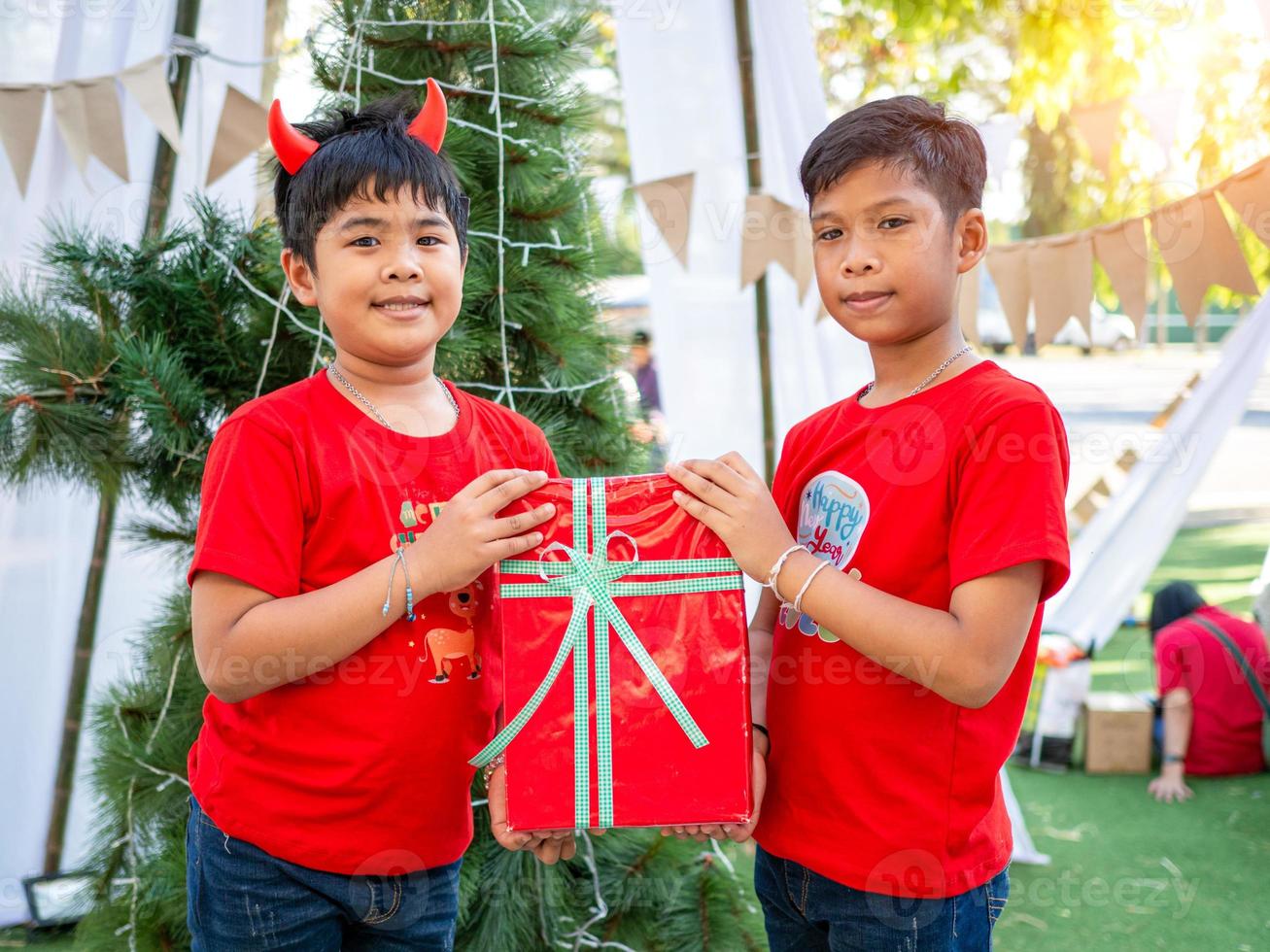 Boy holding presents on Christmas celebration.Christmas festival. photo