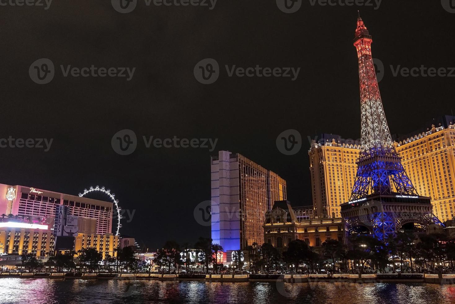 Illuminated Replica of Eiffel Tower at promenade with sky in background at night photo