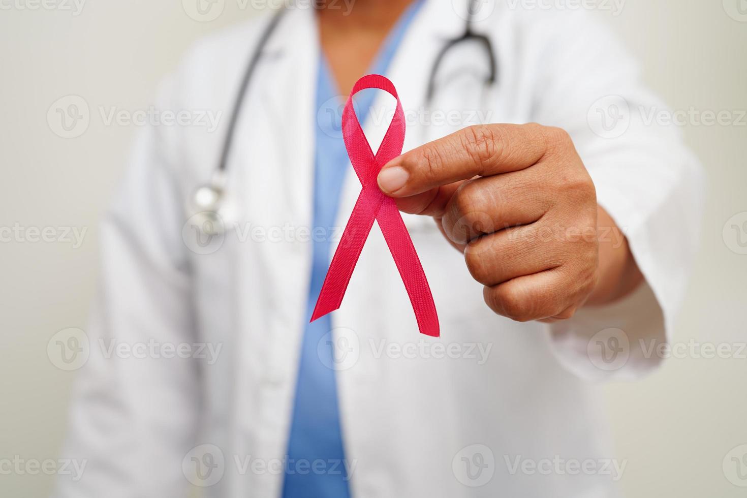 Asian woman doctor with pink ribbon, World Breast Cancer Day at October. photo