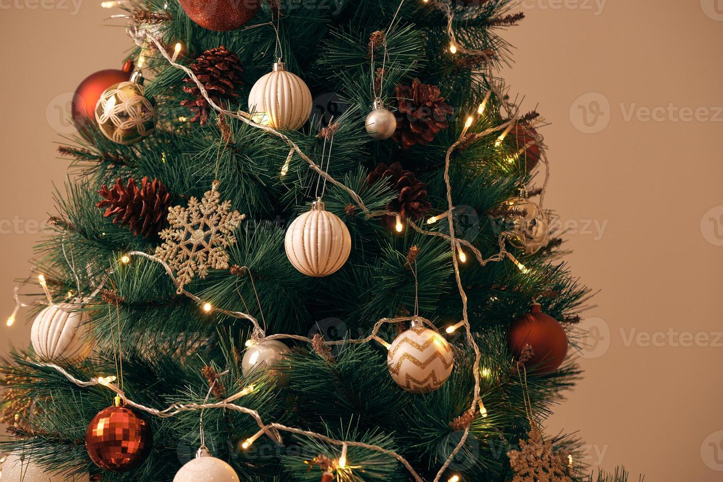 Decorated Christmas tree on blurred, sparkling and fairy background photo