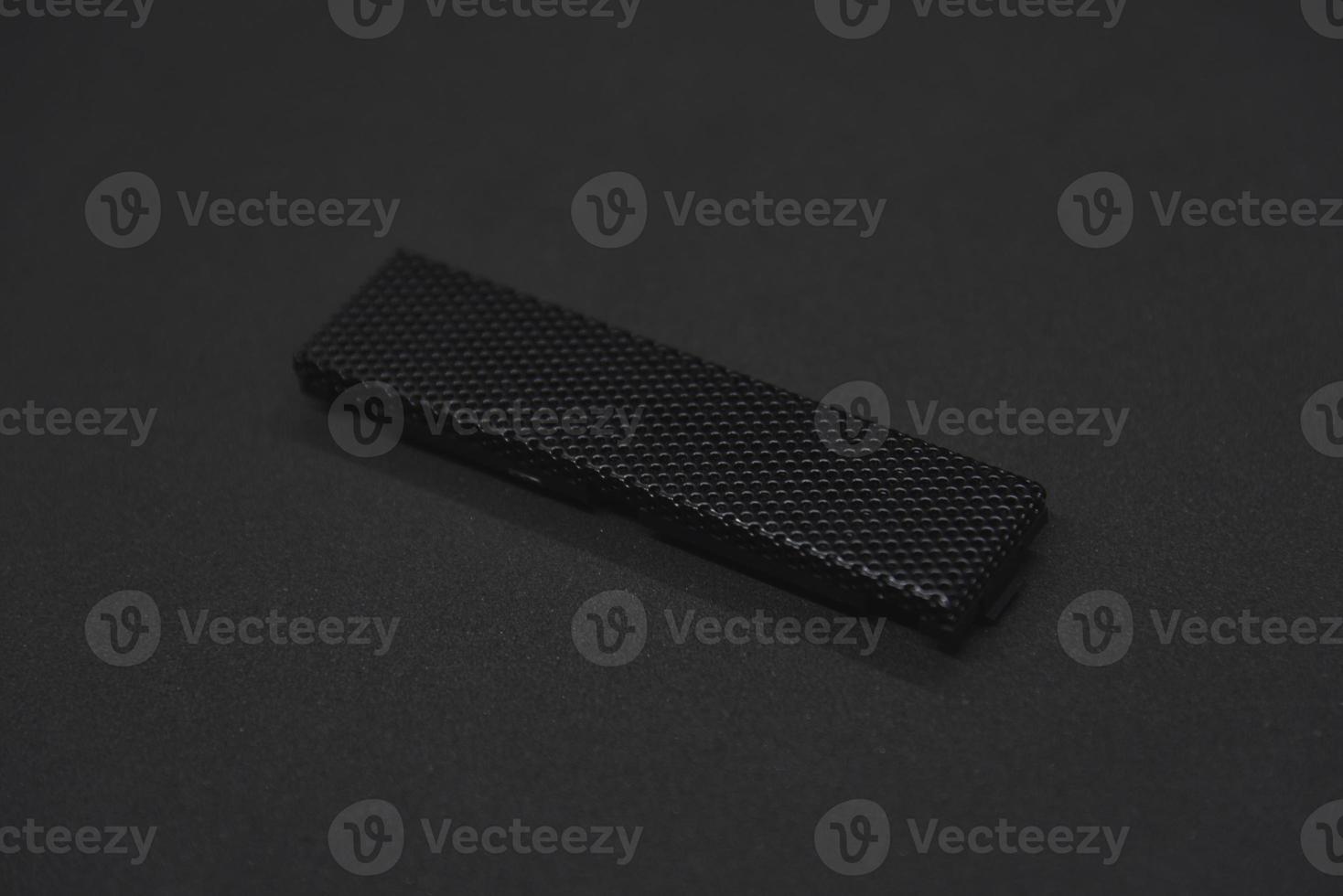 The iron panel from the computer. Iron black mesh panel. Metal rectangular panel on a black background. Beautiful iron rectangular black shape. photo