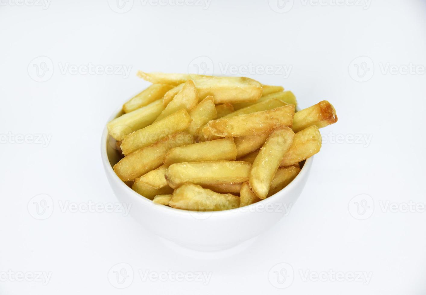 Yellow delicious French fries in white dishes. Fast food on a plate. Fried potatoes. Toasted potato slices on a white background. photo