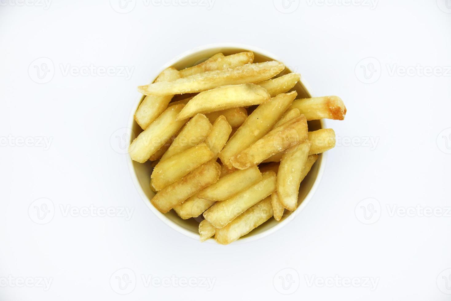 Yellow delicious French fries in white dishes. Fast food on a plate. Fried potatoes. Toasted potato slices on a white background. photo